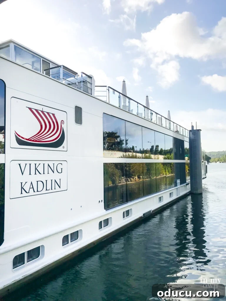 An Iconic Viking Journey Along the Seine 4 Viking Longship Kadlin sailing past picturesque French towns along the Seine River, a common sight on Viking river cruises.