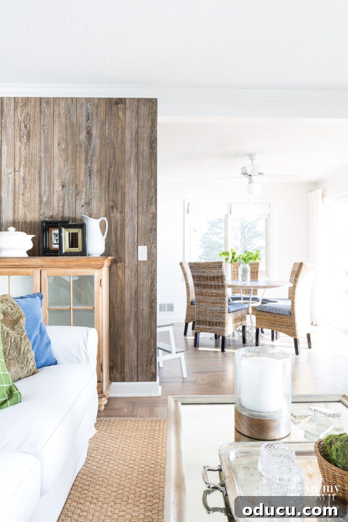 Dramatic Living Room Transformation 10 Barnwood Grey paneling added as an accent wall in a modern rustic white and woodsy decor, enhancing the living room's character