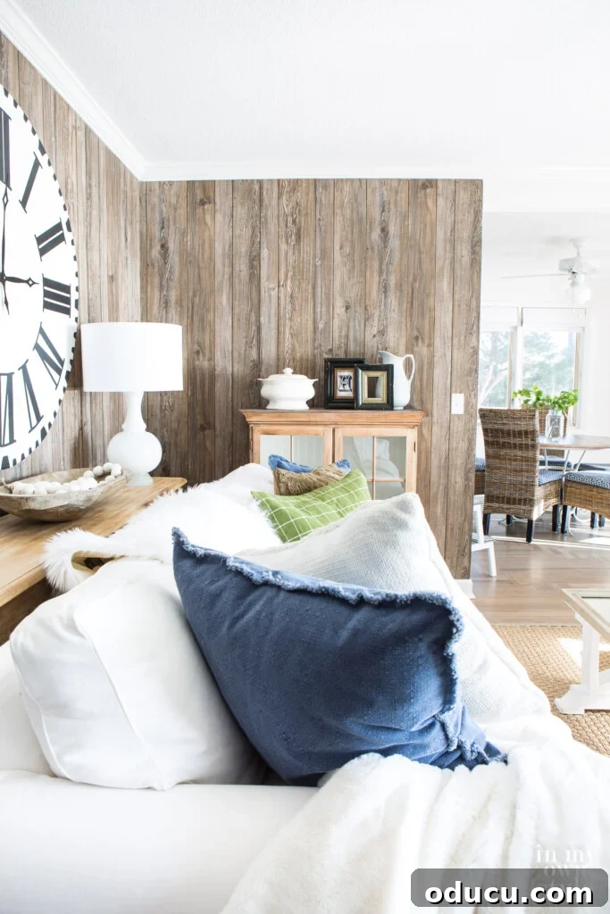 Dramatic Living Room Transformation 11 Barnwood Vertical Paneling on an accent wall in a living room, blending rustic and modern elements