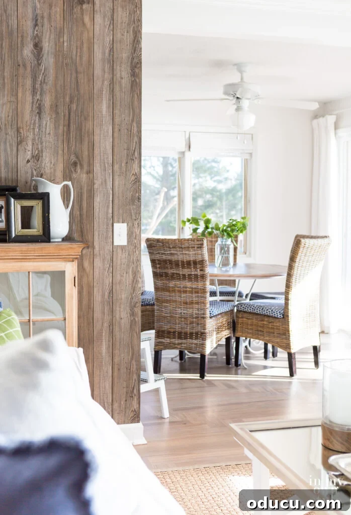 Dramatic Living Room Transformation 12 Barnwood Grey paneling added as an accent wall in a modern rustic white and woodsy decor, showcasing the transformative power of budget-friendly materials