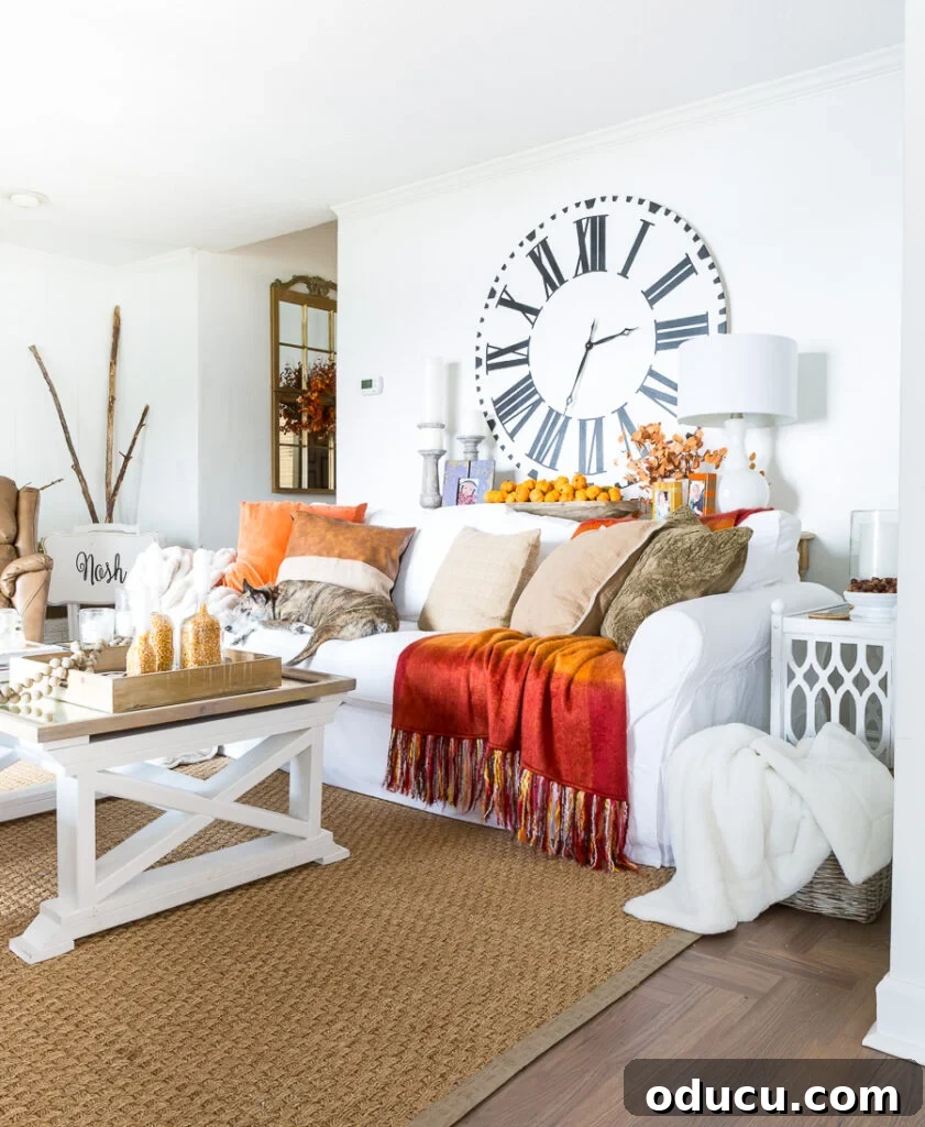 Dramatic Living Room Transformation 3 Bloggers Fall home tour living room decorated in fall colors of orange and brown with a navy accent, showcasing evolving decor styles
