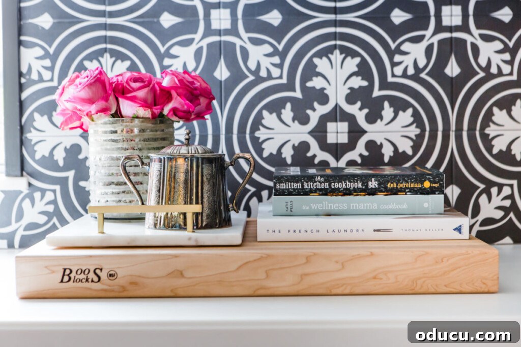 Transform Your Kitchen Counters: 4 Quick Styling Tips 2 Roses in a silver vase on kitchen counter.