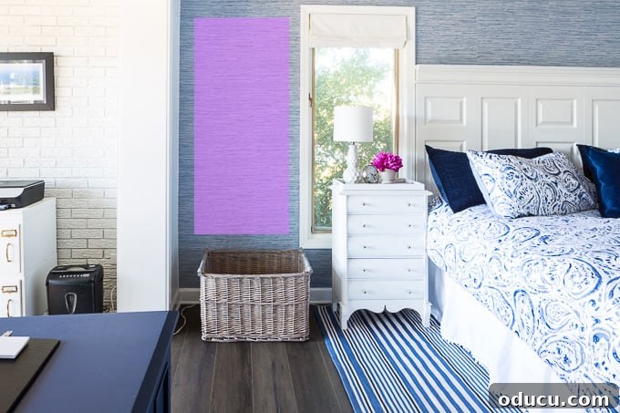 Curate Your Walls Like a Pro 5 A tall, narrow framed picture perfectly fitting a vertical rectangular wall space in a bedroom, demonstrating correct art scale.