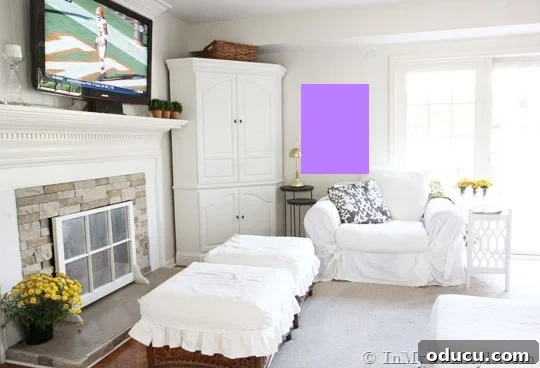 Curate Your Walls Like a Pro 7 A large vertical rectangular art piece hung on a wall with a lamp and table in front, illustrating picture-hanging tricks for layering.