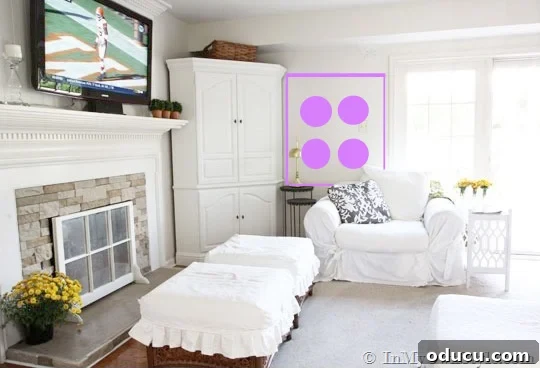 Curate Your Walls Like a Pro 9 An arrangement of various shaped art pieces forming a cohesive vertical rectangle on a wall, offering tips for hanging art around furniture.