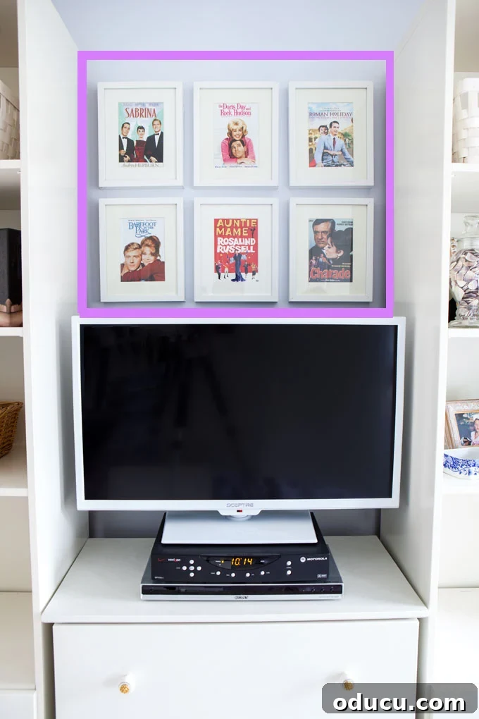 Curate Your Walls Like a Pro 10 A grid pattern of art pieces arranged horizontally above a TV, serving as a wall art arrangement tip.