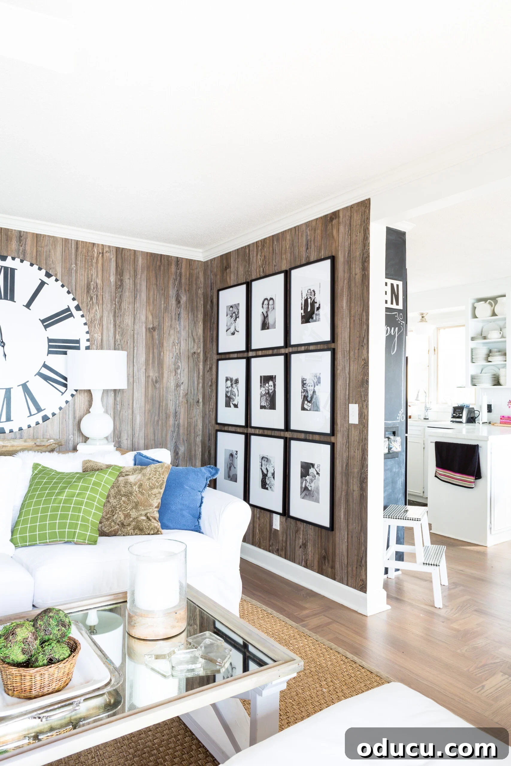 Living room wall featuring a completed 9-grid black and white photo gallery wall, with a final level check on the perimeter.