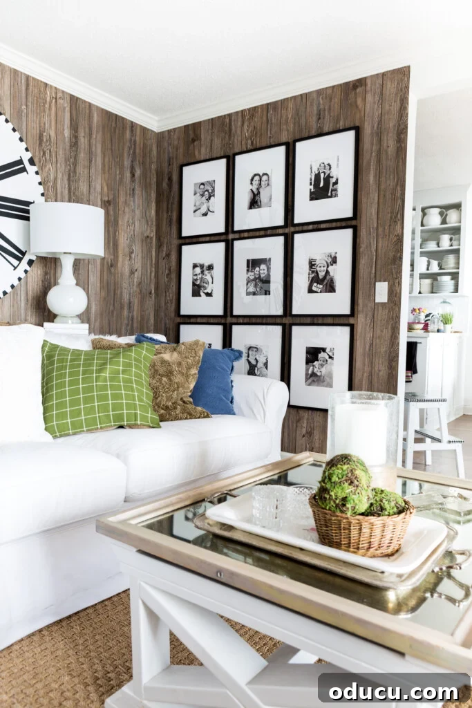 A beautifully hung and perfectly level grid gallery wall, featuring black and white photos in a living room.