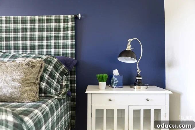 Awaken Your Home For Spring 12 Blue accent wall in bedroom. Bed has a green black and white checked headboard and sheets.