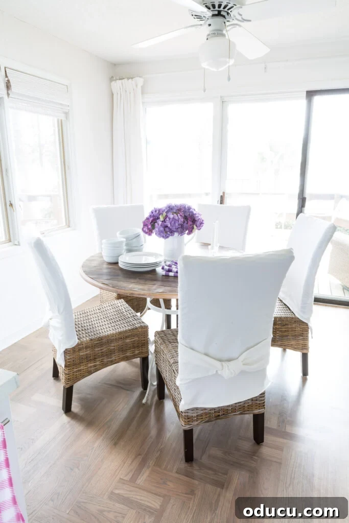 Awaken Your Home For Spring 16 Simple spring dining room decor in lake house kitchen. White slipcovers over rattan chairs.