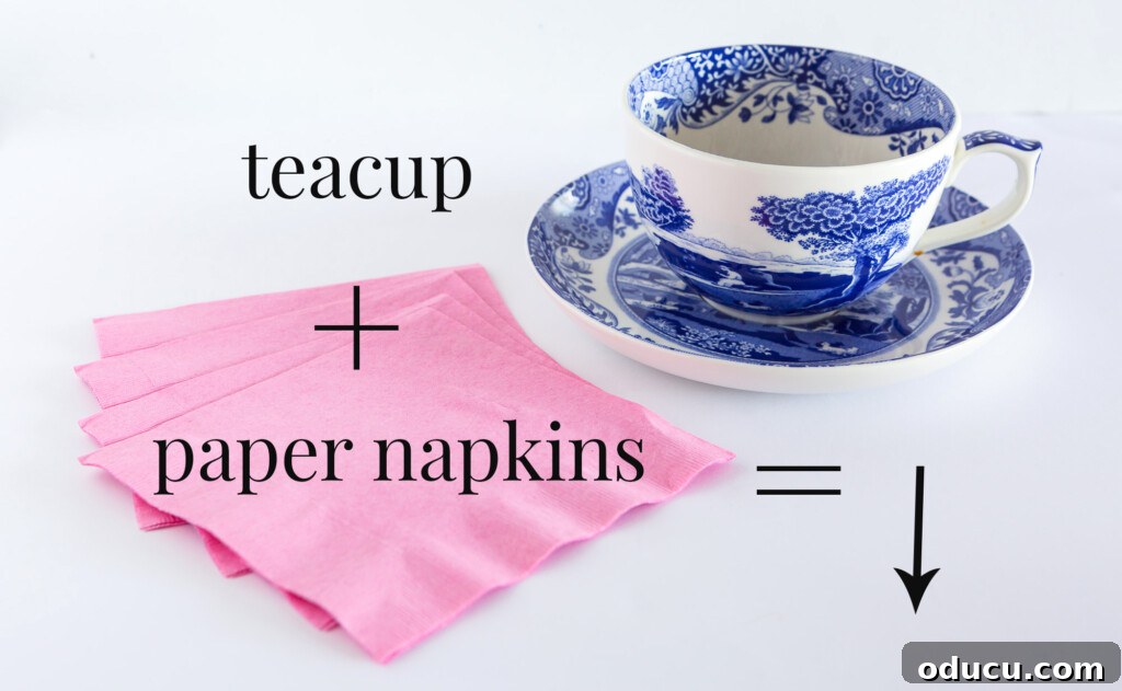 A pile of pink paper napkins and a blue and white china teacup, showing supplies for paper flower DIY.