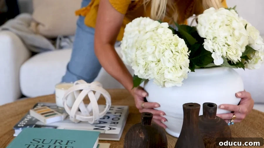 Transform Your Ceramics with Spray Paint 3 White terracotta ceramic glazed planter vase being placed on a coffee table