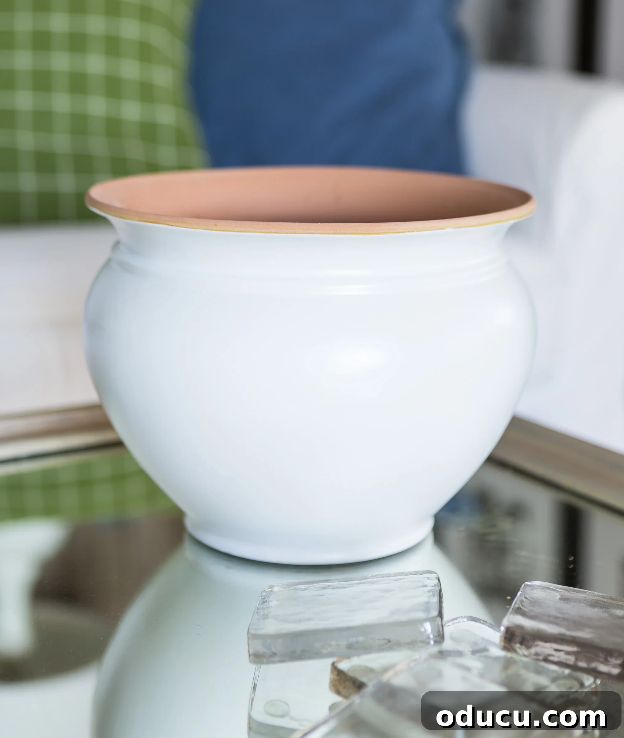 Smooth white spray painted finish on a terra cotta planter.