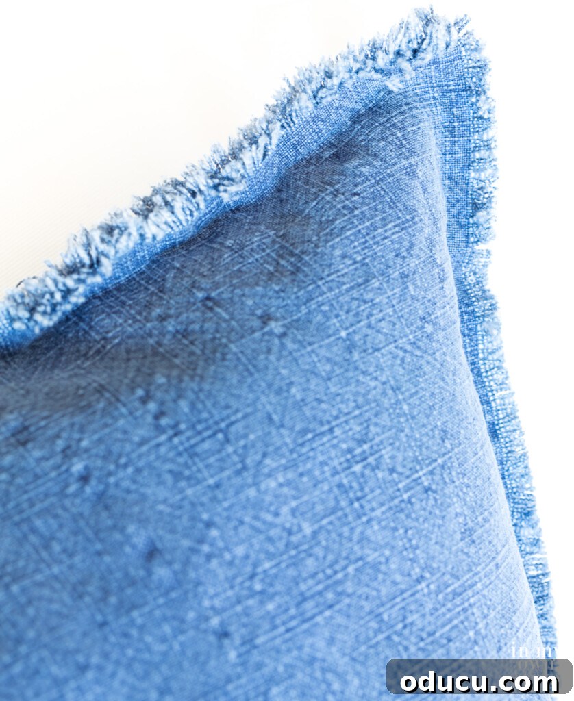 Crafting Custom Pillow Fringe 3 Blue chambray pillow with DIY fringed fabric edges, inspiring a similar green pillow project.