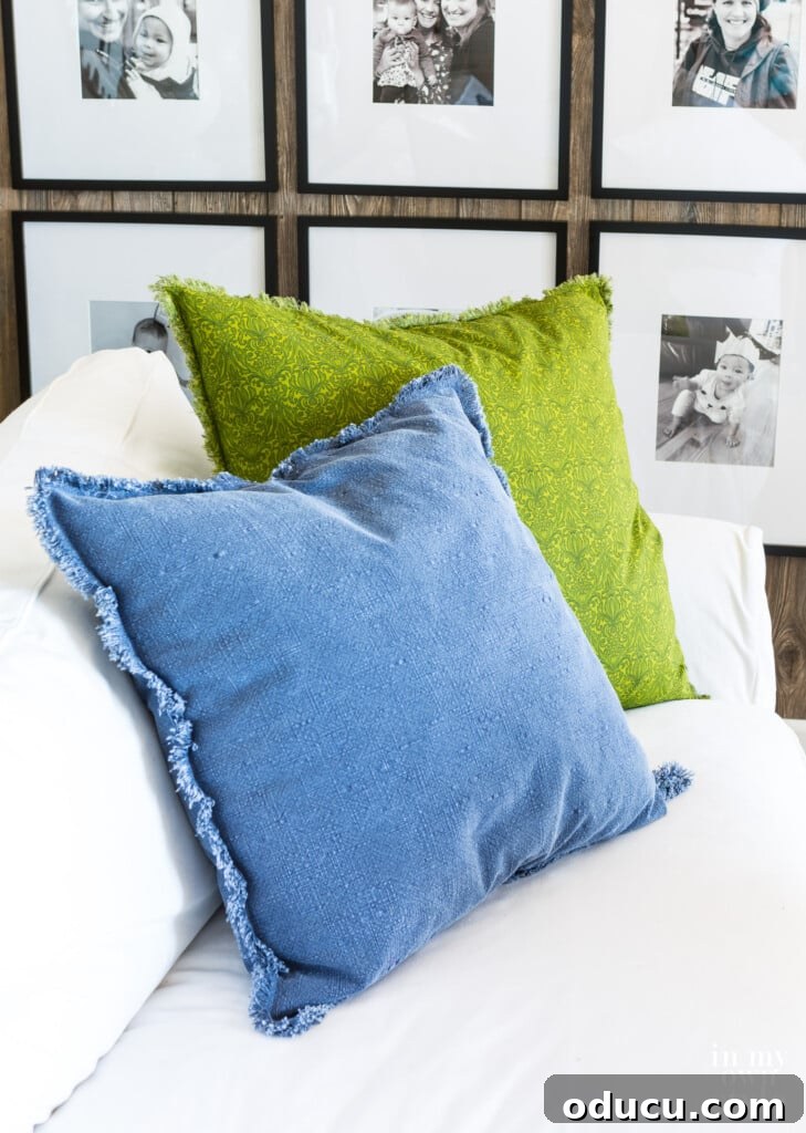 Crafting Custom Pillow Fringe 4 Two fringed edge pillows on a white sofa: one blue denim, one spring green. Both feature easy DIY fringe.