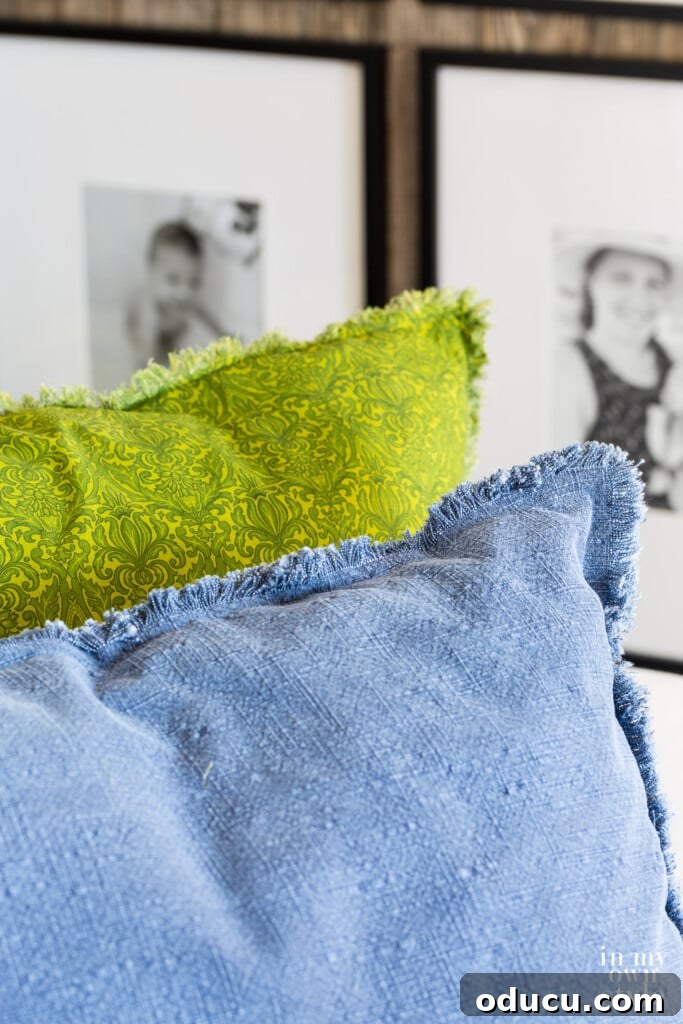 Crafting Custom Pillow Fringe 5 Two large fringed edge pillows, green and blue, add texture and color to a sofa.