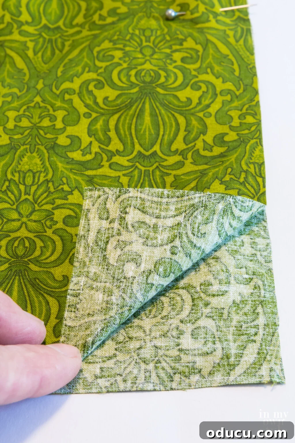 Lay pillow cover fabric wrong sides together for a fringed edge pillow.