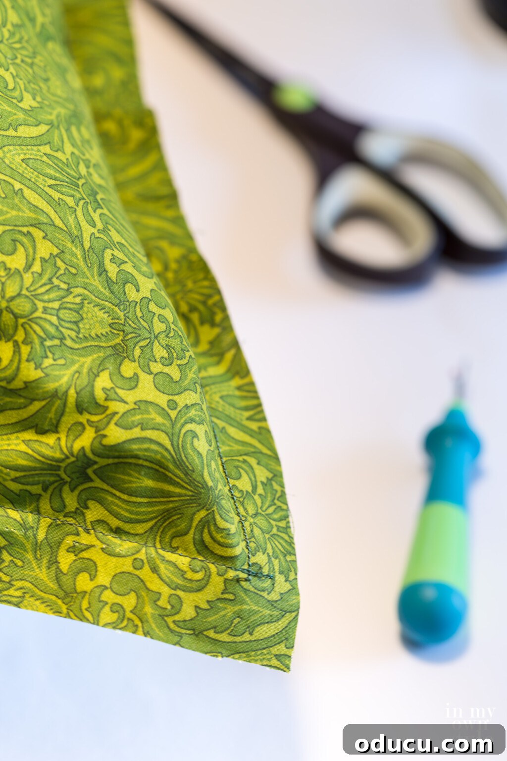 Sew front and back of pillow cover fabric together on a sewing machine, leaving a fringed border.
