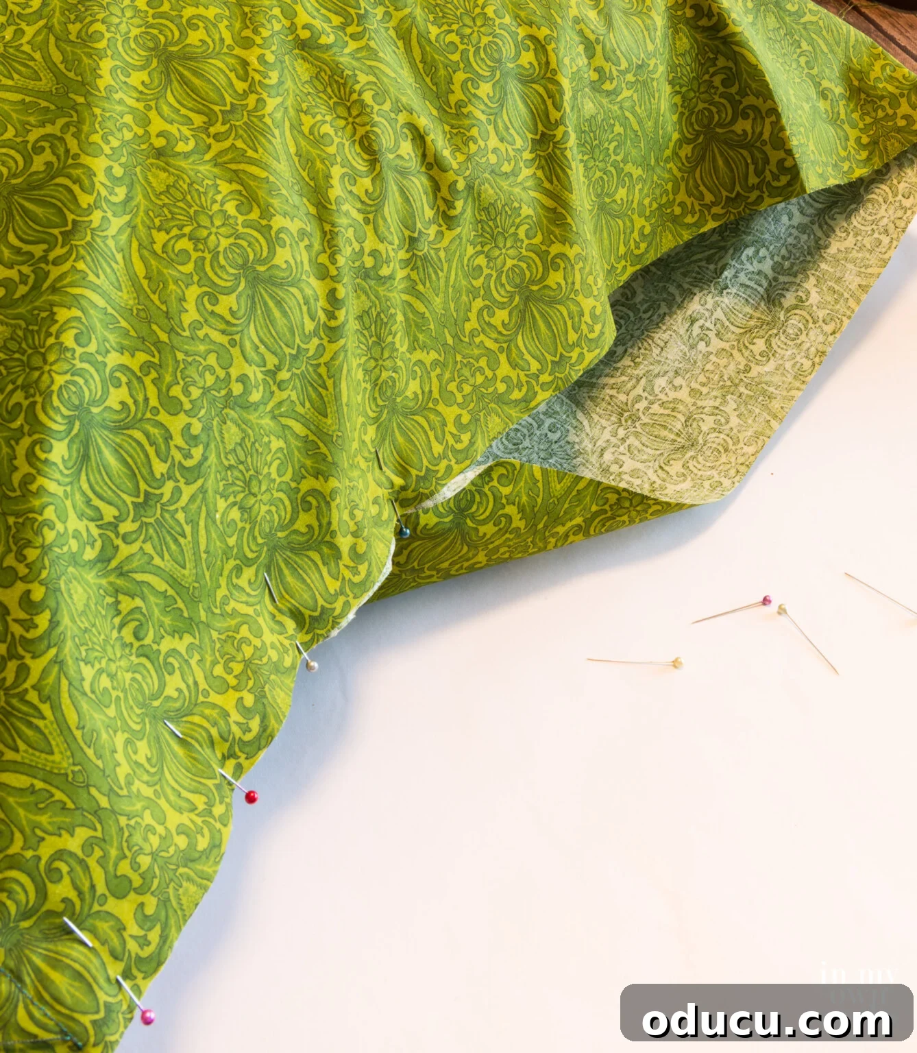 Pin and close the last side of the pillow cover with the form inside for a fringed pillow.