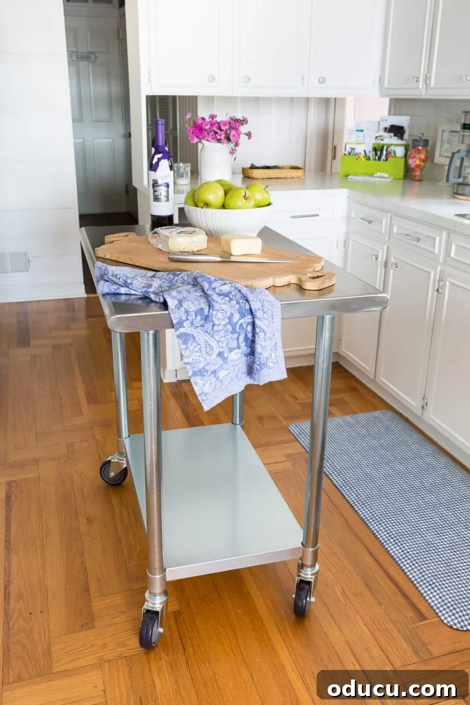 Center kitchen island on wheels providing versatile storage and workspace.