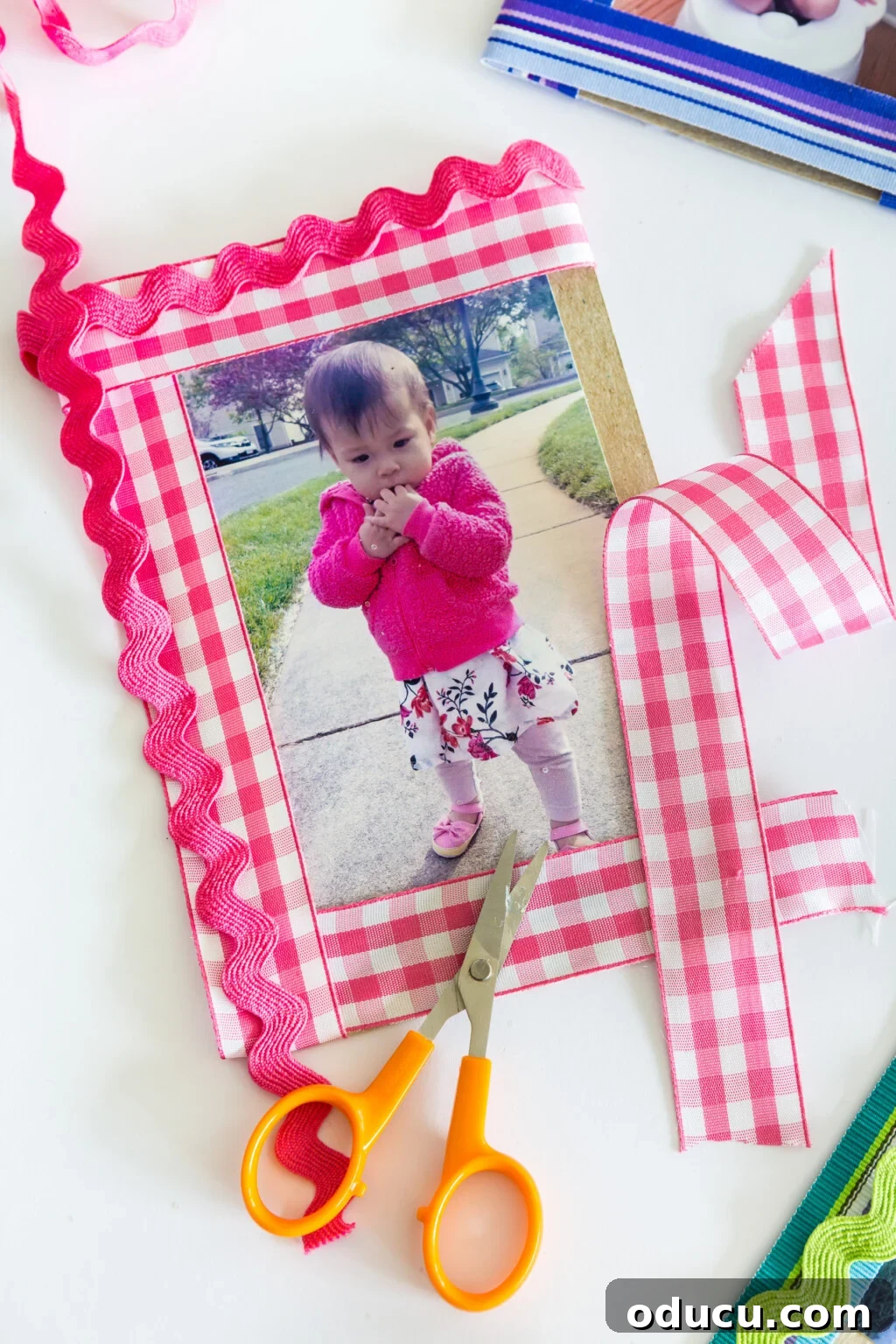 Pink and white gingham ribbon used to create a photo frame mat for a small picture frame.