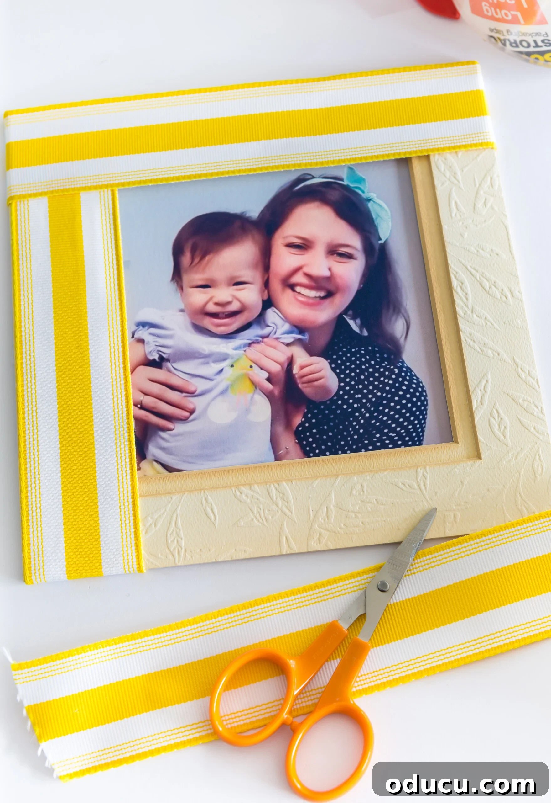 Yellow and white stripe ribbon scraps made into a picture frame mat, showcasing a vibrant design.