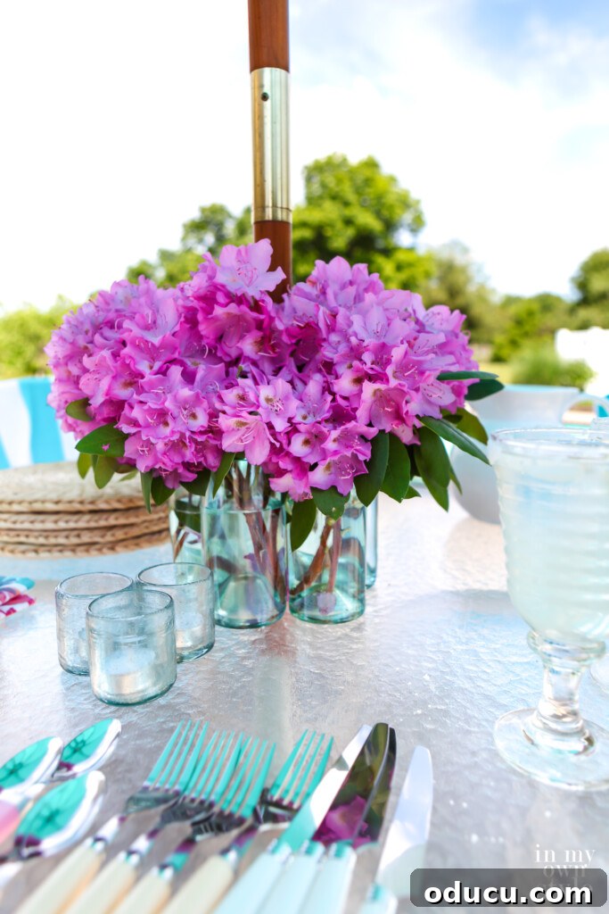 Effortless Chic Patio Umbrella Centerpiece 3 DIY glass bottle vase to go around an umbrella hole and pole on a patio table
