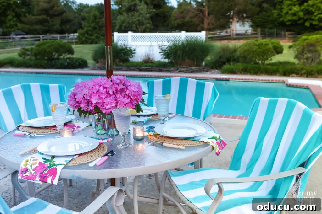 Effortless Chic Patio Umbrella Centerpiece 4 Centerpiece vase for patio table with an umbrella. White and teal striped beach towels on chairs used as casual but coloful covers.