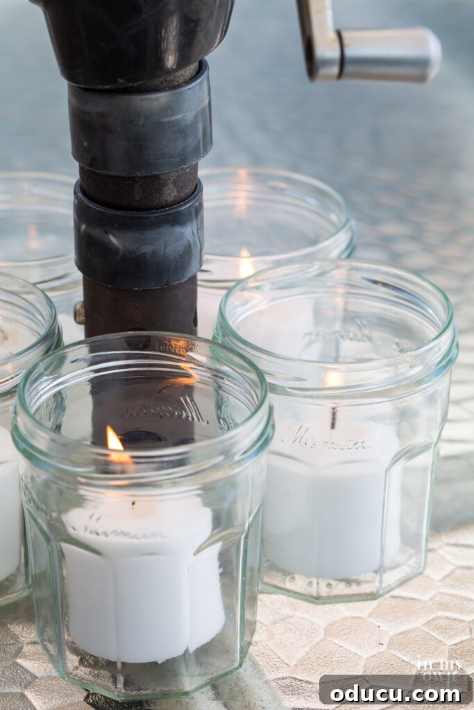 Effortless Chic Patio Umbrella Centerpiece 9 Close up of lit jelly jars Candle Centerpiece for Patio Umbrella Table
