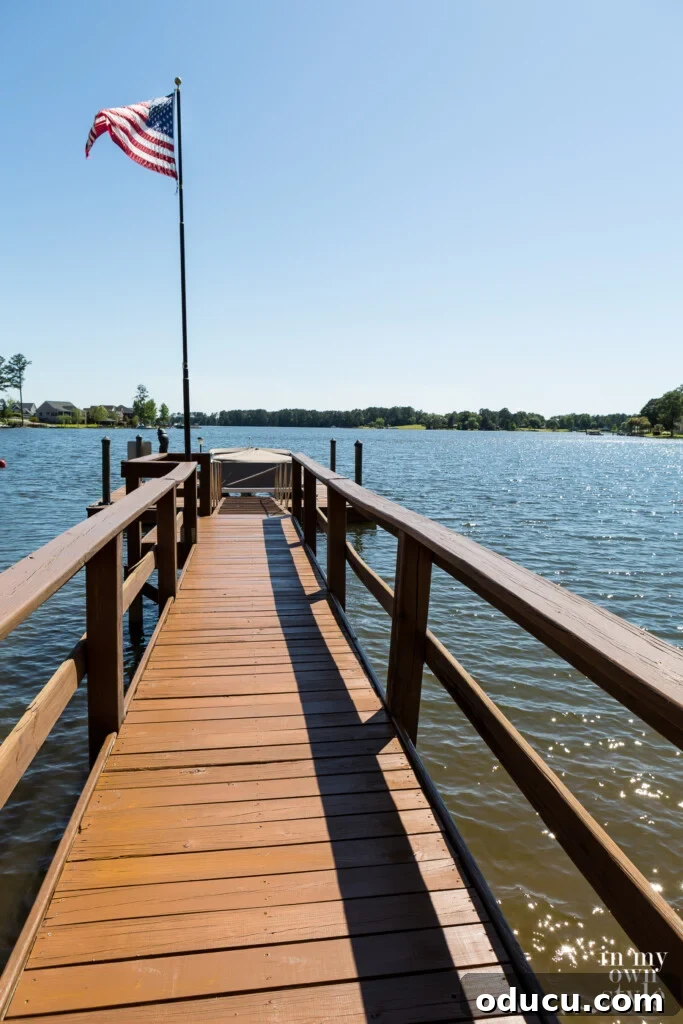 A Personal Reckoning 11 Long lake dock after getting stained, American flag blowing in the breeze.