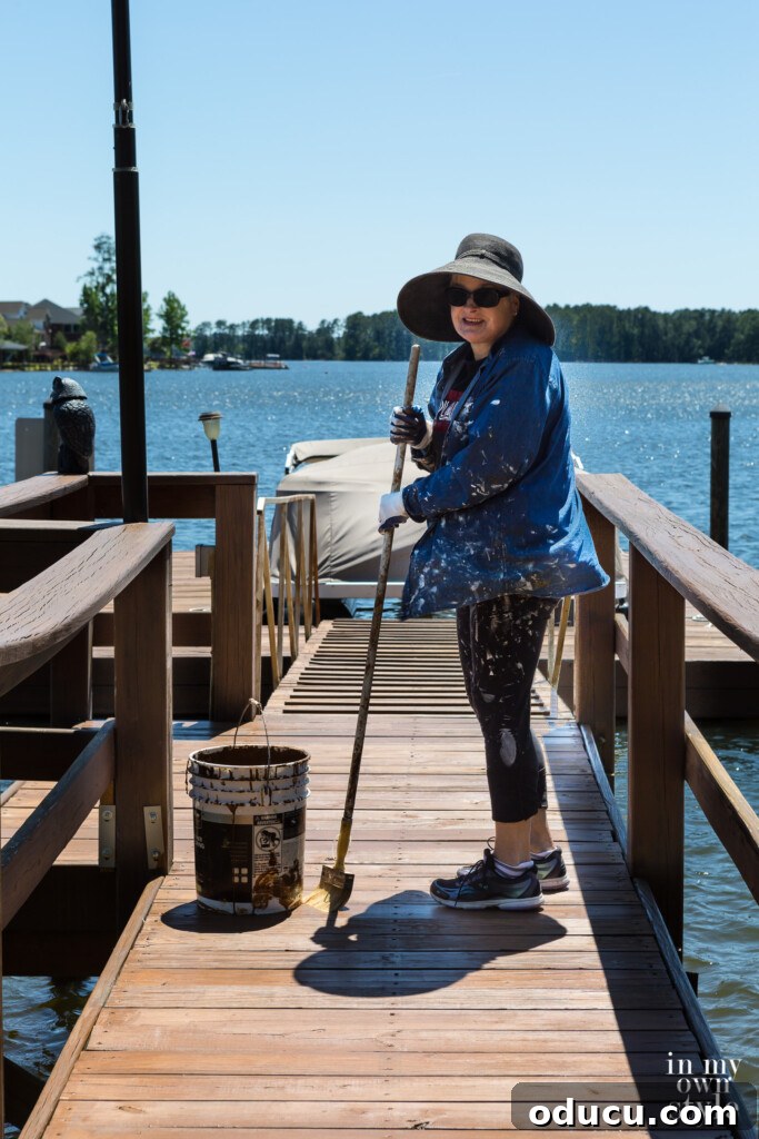 A Personal Reckoning 3 Diane with hat and sunglasses Staining the dock on Lake Murray