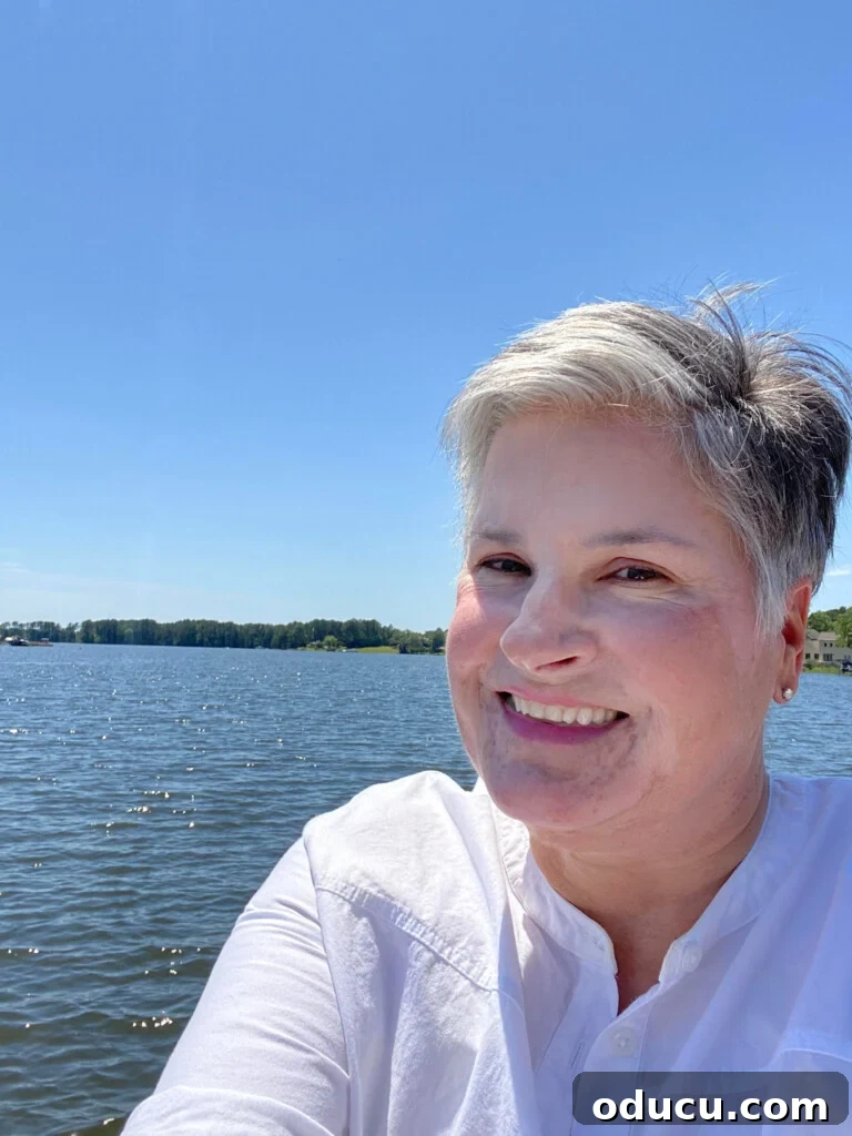 A Personal Reckoning 5 blogger In My Own Style standing and smiling at camera on lakeside dock without hat on.
