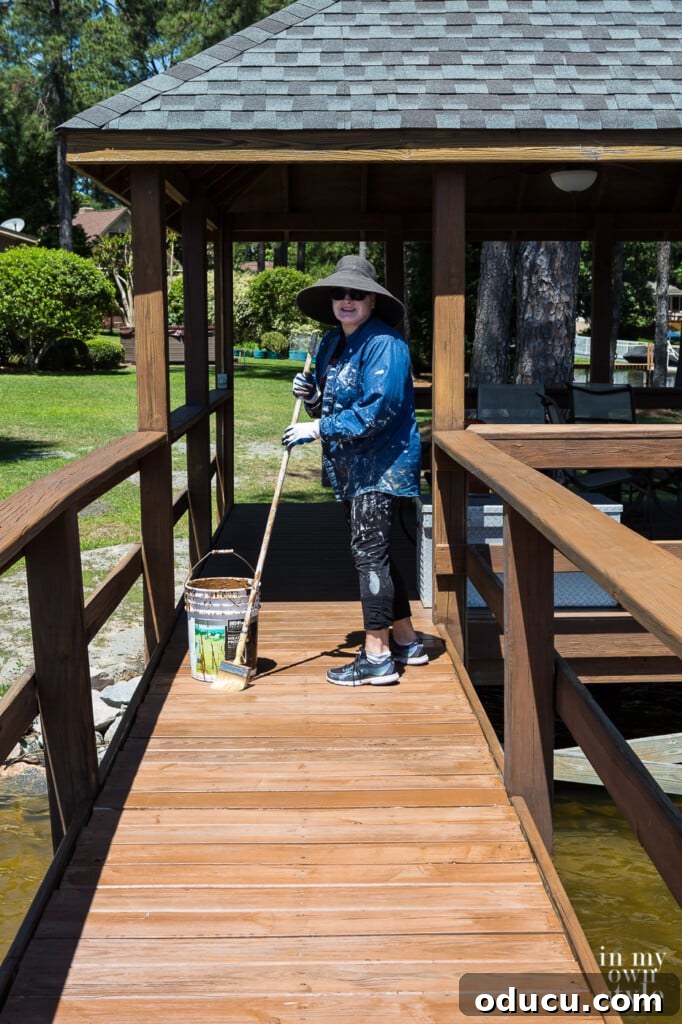 A Personal Reckoning 10 Lakefront Gazebo and dock floor being stained by Diane