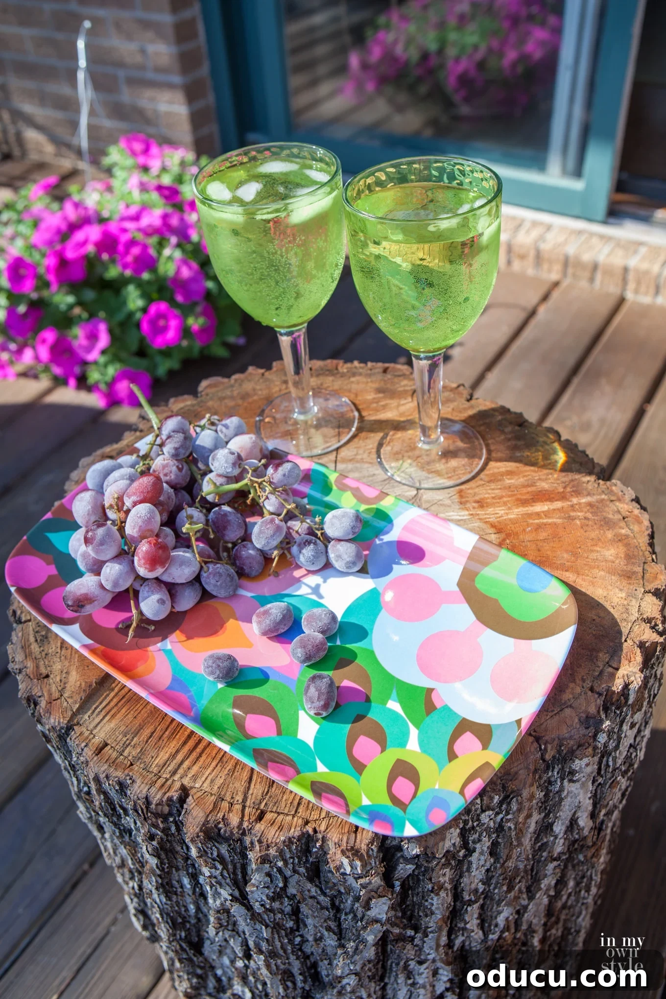 Craft a Unique Tree Trunk Outdoor Table 4 Outdoor dining setup featuring a tree trunk table holding a serving platter, surrounded by natural elements.