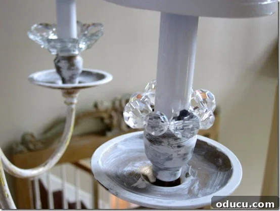 Sliding the bead ring over the chandelier candle