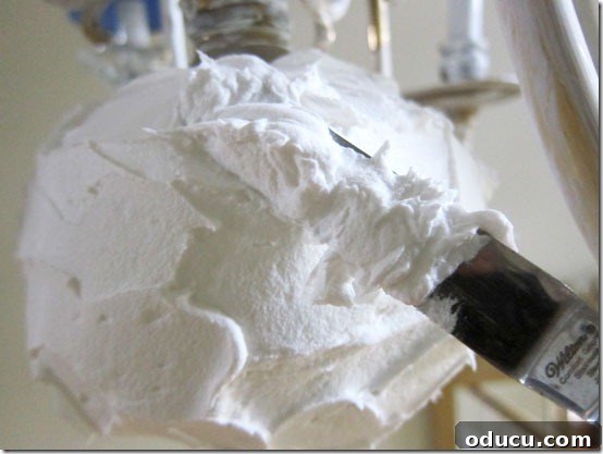 Spreading lightweight Spackle on the chandelier brass ball
