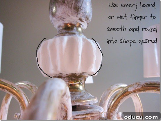 Using fingers to shape dry Spackle on the chandelier