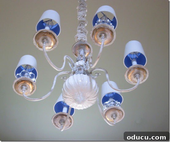 Distressed brass elements of the chandelier makeover