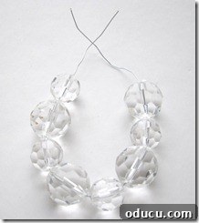 Stringing beads onto craft wire to make a bobeche