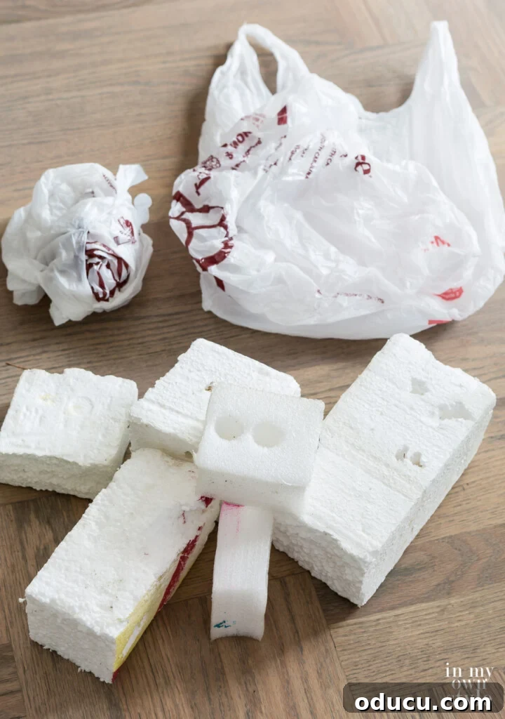 Statement Decor: Creative Ways with Large Baskets 3 Assortment of foam pieces and balled-up plastic bags laid out on the floor, designated for filling a large decorative basket before adding faux flowers.