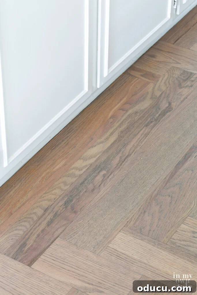 Effortless Summer Style 11 Bona Flooring Grey Stained floor in kitchen.