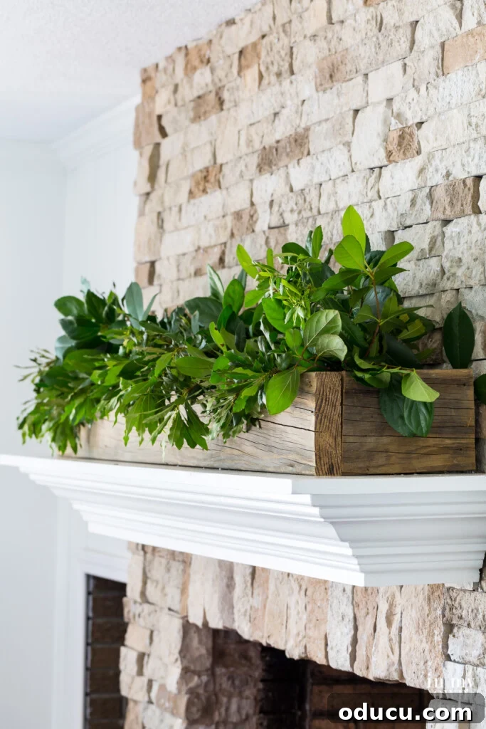Effortless Summer Style 8 White mantel on stone fireplace with wood planter box filled with greenery is my go to summer decorating idea.
