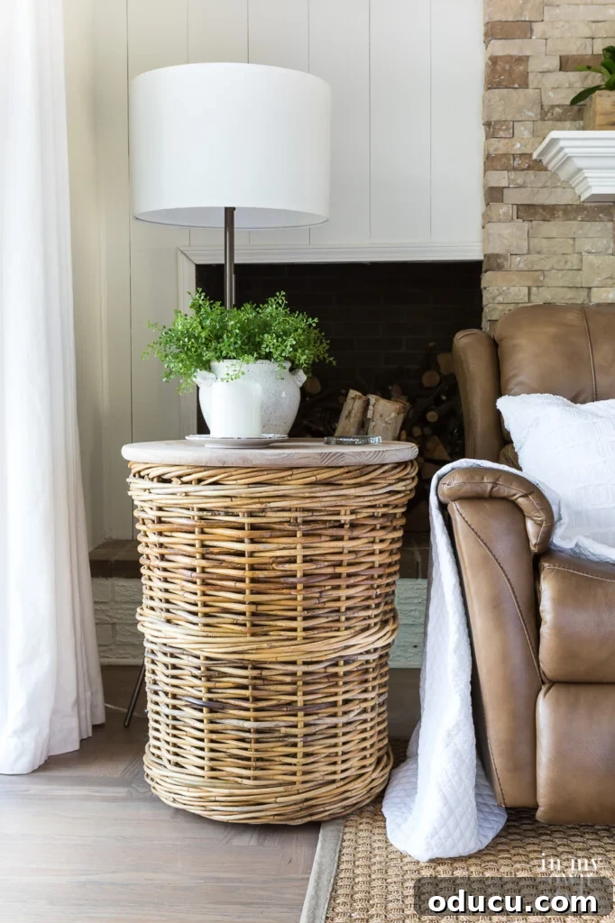 Transform Your Wicker Basket into a Stylish Side Table 4 Large basket made into a diy end table. It sits next to a brown chair with a white throw and pollow.
