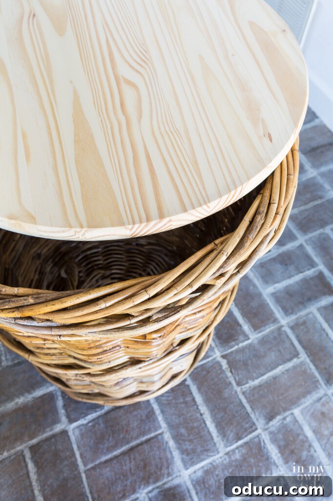 Transform Your Wicker Basket into a Stylish Side Table 6 Round wood top placed on top of large wicker basket, demonstrating the side table structure.