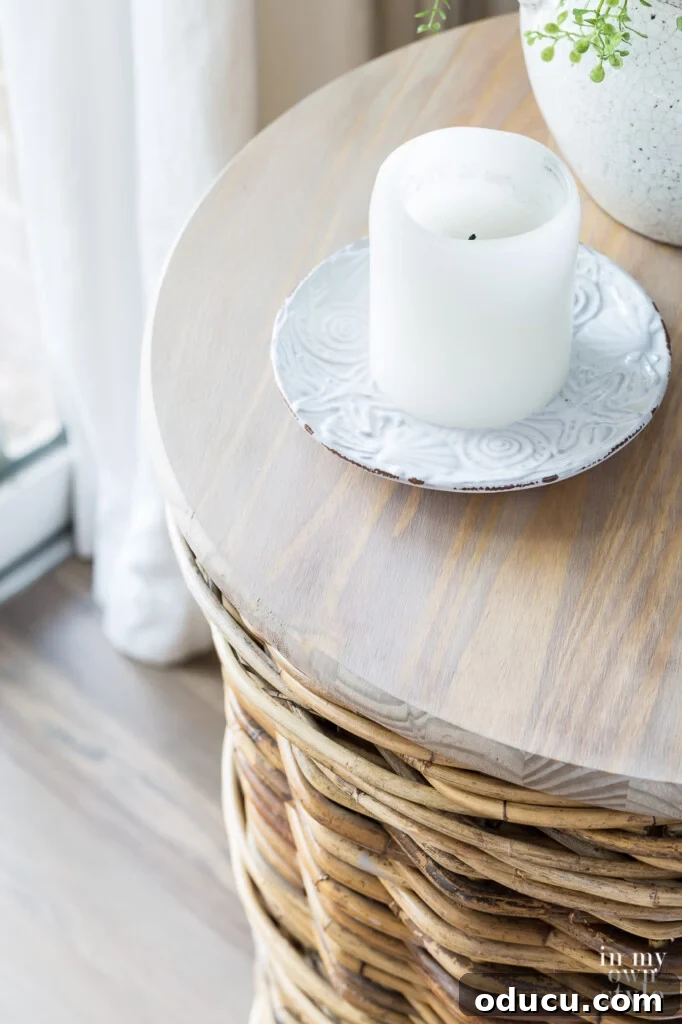 Transform Your Wicker Basket into a Stylish Side Table 9 Looking down at the wood top of a basket side table with a candle on a plate.