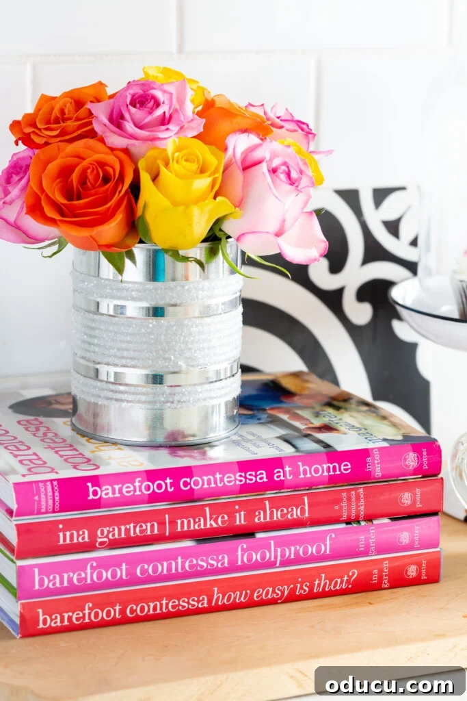 My Kitchen's Muse: Tools That Ignite Culinary Desire 8 Tin can vase on a stack of books on a kitchen counter.