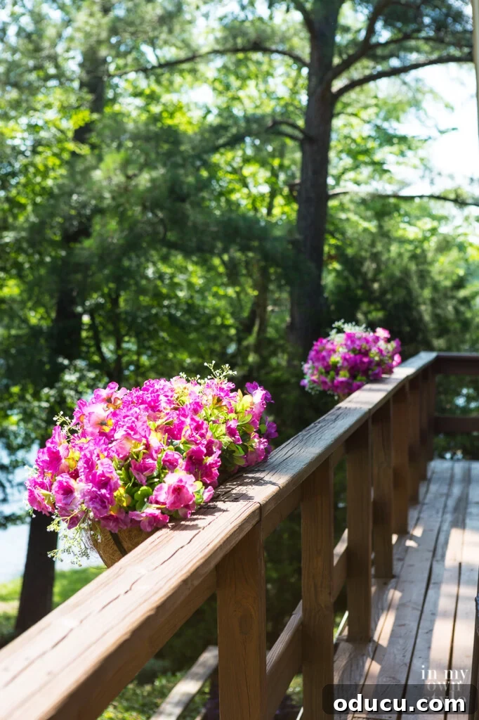 Lakeside Deck Rail Planter Boxes 5 Window box flower planters with fake flowers on deck railing.