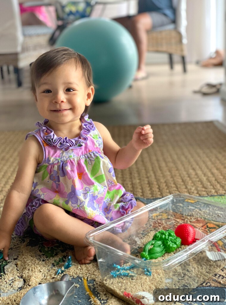 Unlock Your Signature Style Elevate Your Home 3 Grand baby sitting on the floor, happily playing with a box of toys, a scene of innocent joy.