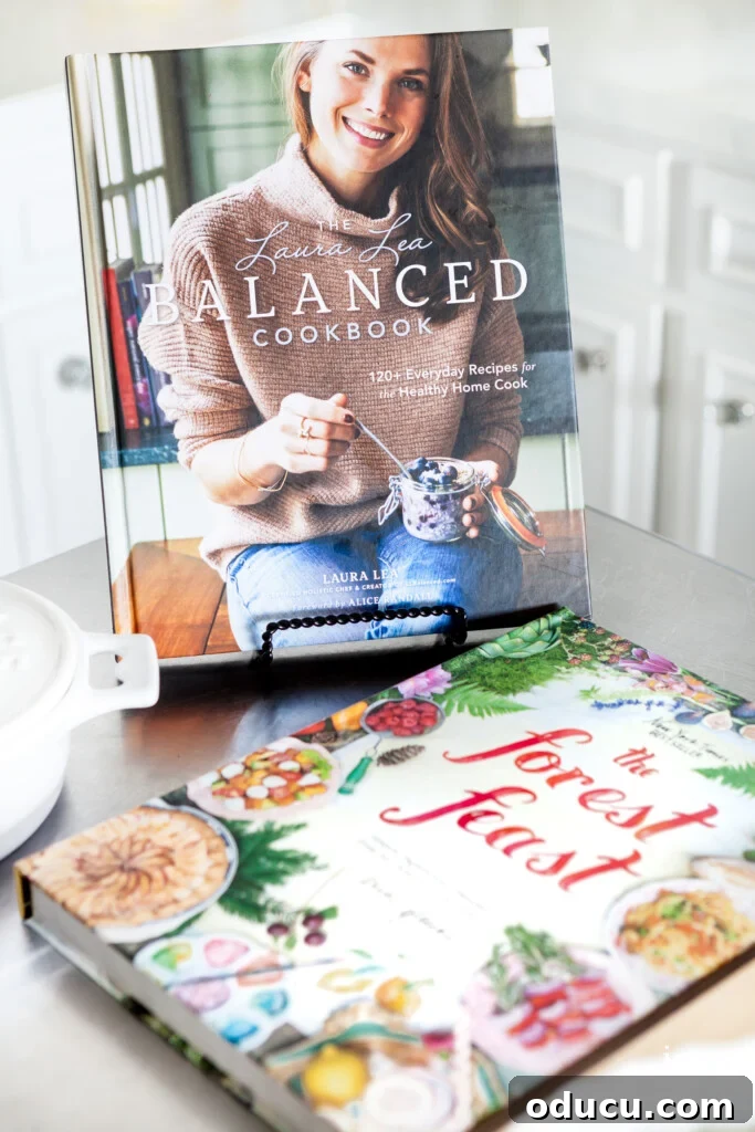 Cultivating Your Creative Sanctuary 13 LL Balanced and The Forest Feast Cookbooks on kitchen island, inspiring healthy and fresh meals.