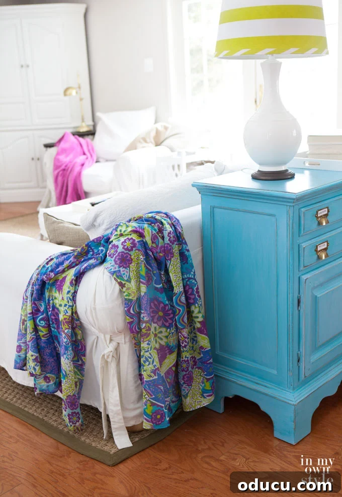 Instant Summer Room Makeover 5 A vibrant pareo draped over a neutral armchair, illustrating how to brighten up a room with color on a small decorating budget.